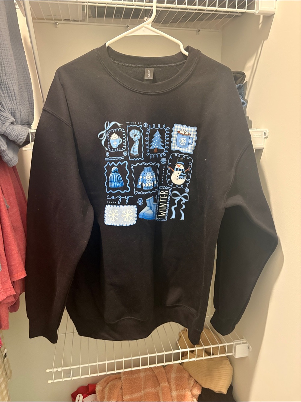 Womenโs Cozy Winter Graphic Crewneck Sweater - Black with Blue Accents